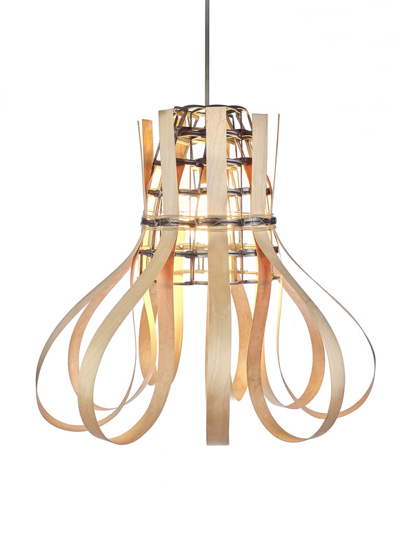 Single bulb suspended sculptural lighting with conical frame made from scrap metal opening downward and long strips of thick wooden reed woven into the metal and then looped down. Created by Lucy Slivinski 