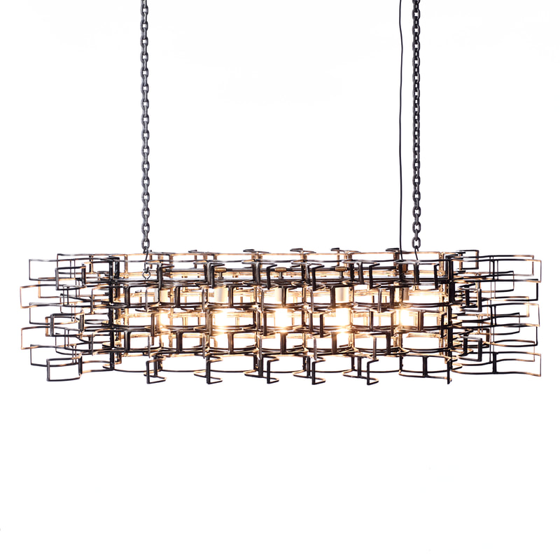 Suspended light fixture with five light bulbs in a horizontal line. Metal frame surrounds bulbs in geometric fashion. Created by Lucy Slivinski.