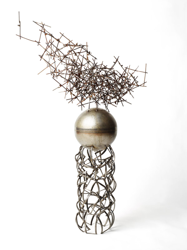 Abstract metal sculpture made from salvaged metal. Created by Lucy Slivinski. 