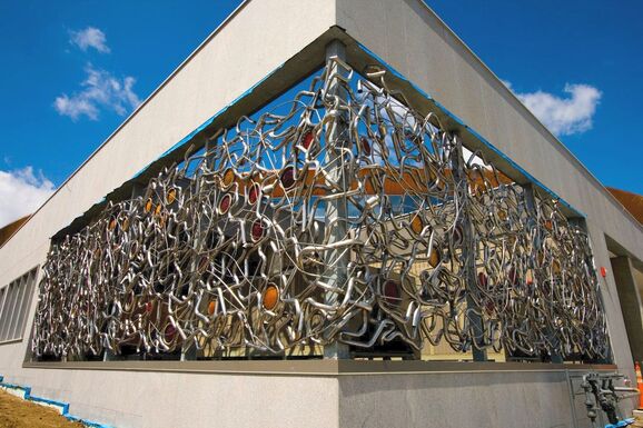 Art commission created by Lucy Slivinski using recycled metal wrapped around the corner of the St. Paul, MN library 